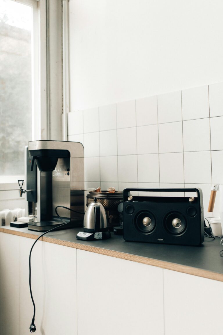 a coffee maker and speakers on a counter kitchen appliances gadgets